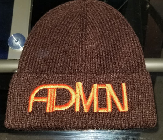 A brown winter beanie with the logo 'ADMIN' written in orange on the fold.